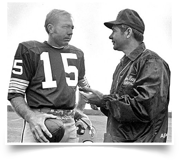 Green Bay Packers Quarterback Bart Starr talking to head coach Dan Devine.